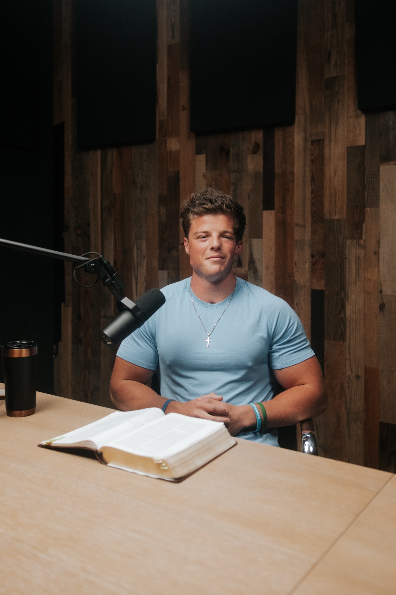 Dylan Mandell in studio with an open Bible