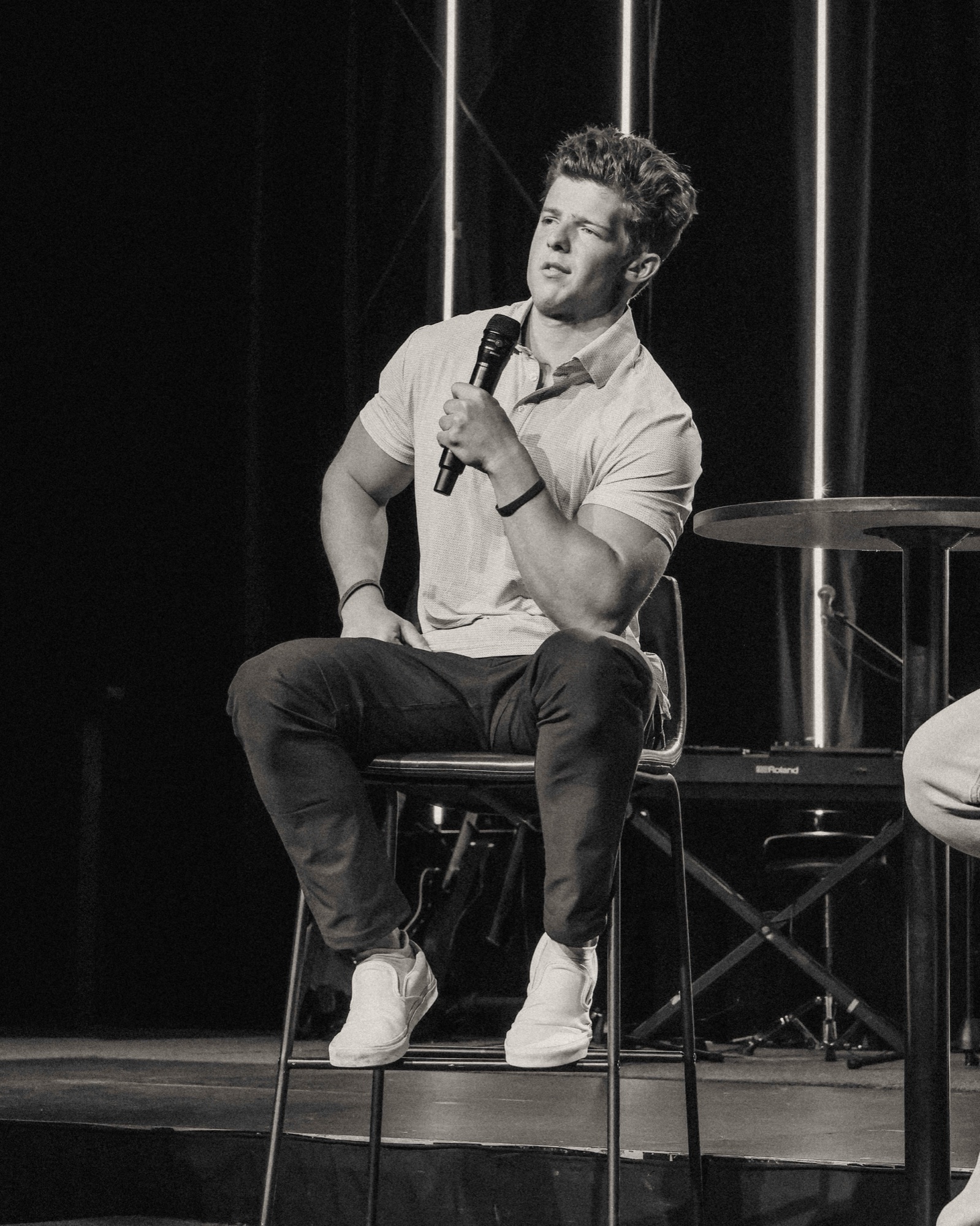Dylan speaking on stage with a microphone