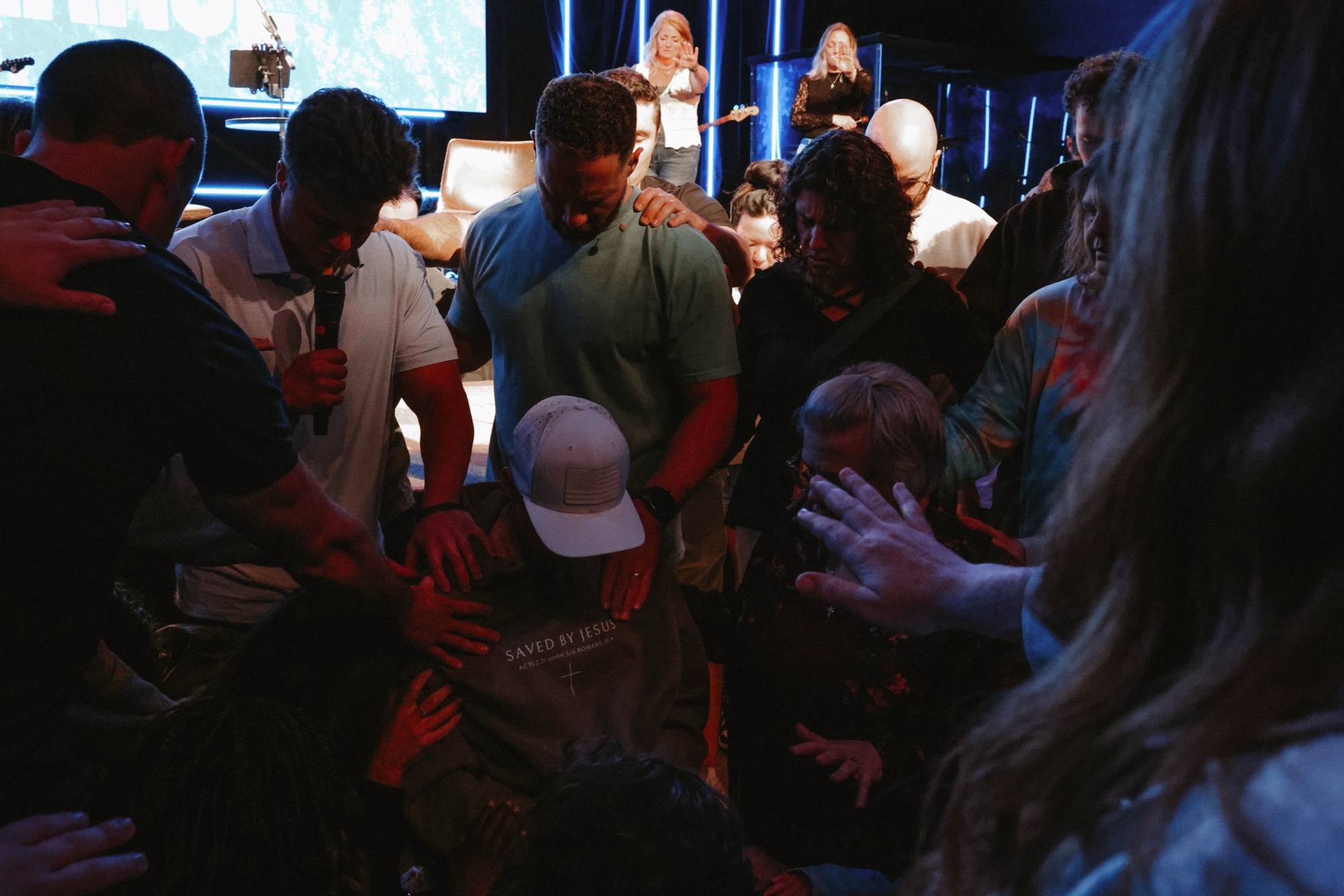 Dylan ministering with a small group in prayer