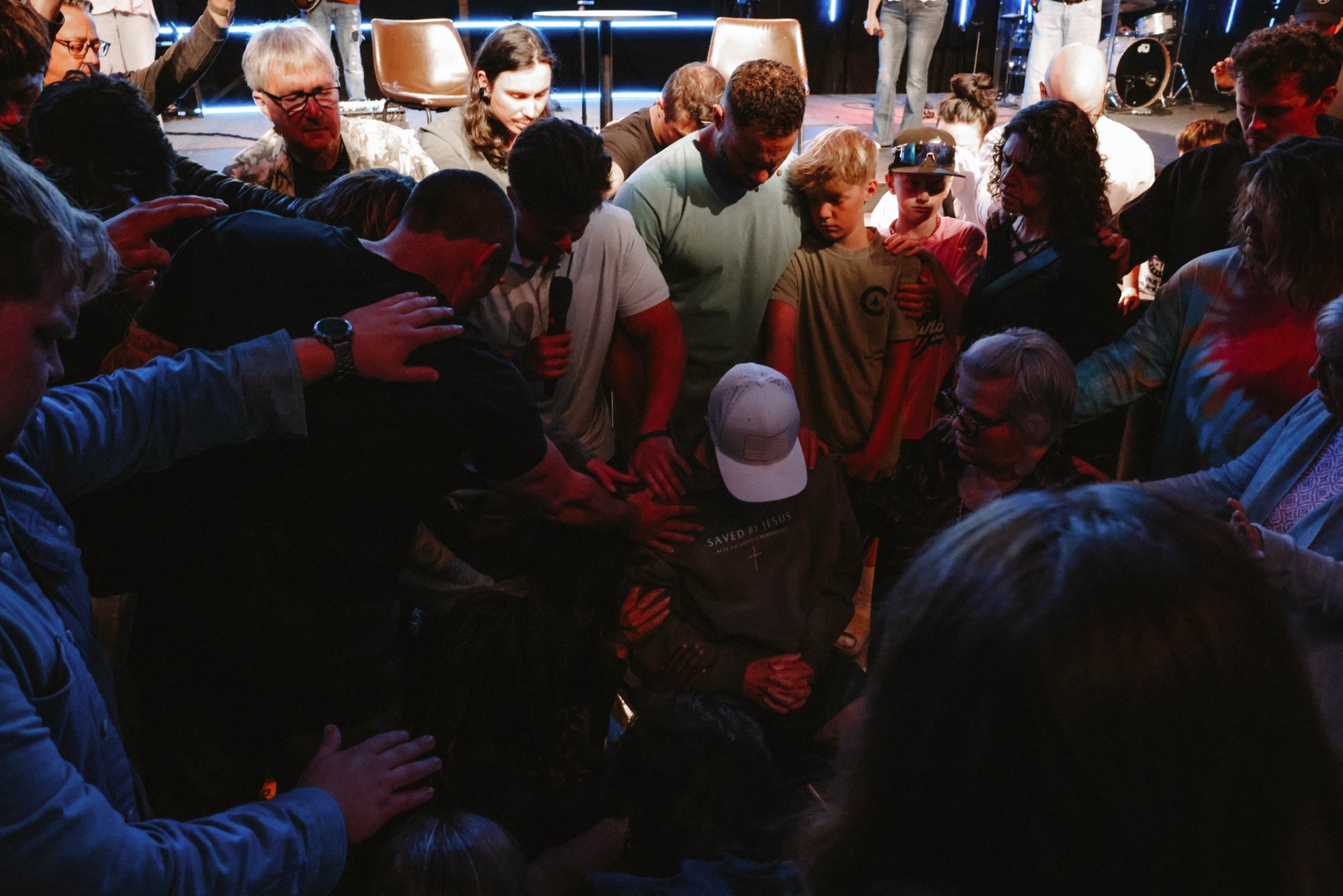 Dylan with hands raised in worship on stage